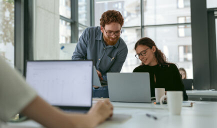 Two colleagues working together on a laptop